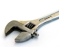 The adjustable wrench grips flat-sided objects, such as hex nuts.