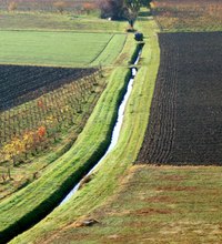 An irrigation ditch transports water to fields for flood irrigation.