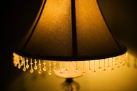 Reline a damaged lampshade with a natural fiber fabric.
