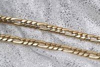 Figaro chains feature oblong links interspersed along the length of the chain.