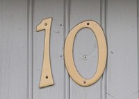 Some house numbers are attached with screws.