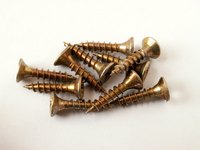 Remove broken screws with a drill and screw extractor.