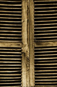 Make your own plantation shutter out of closet doors.