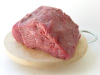 Slice a lean cut of beef into thin strips to make beef jerky.