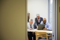 A business meeting in a board room.