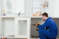 A man building a kitchen.