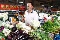 A vendor is selling vegetables in the market.