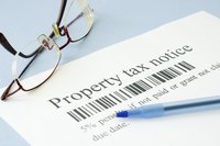 A property tax notice with a pen on a table.