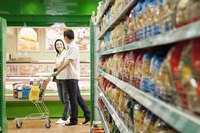 A man and woman are in the supermarket.