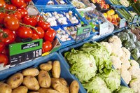 Price signs beside fresh vegetables