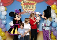 Mickey and Minnie mouse posing with a family.