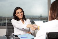 A patent attorney shaking hands with a client