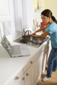 A stainless steel faucet blends with a stainless steel sink.