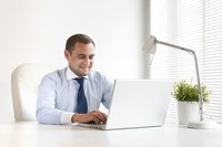 Man typing on laptop at work