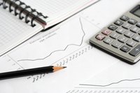 Close-up of calculator over data chart