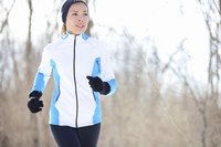 Woman jogging with a fleece jacket.