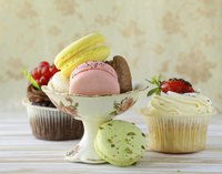 A still life of sweet treats from a bakery on a wooden table.