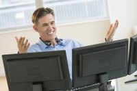 Businessman working on two desktops