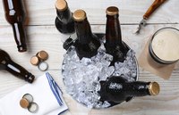 Beers in a bucket filled with ice.