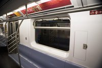 Advertising posters on the inside of a train.