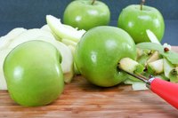 Push the corer through the center of the apple, then twist it to remove the core.