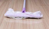 Swiffer sweeper lying on floor beside dog hair