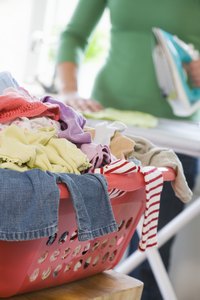 Turn your iron into a clothing steamer with aluminum foil.