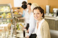 A smiling woman in line at a cafeteria