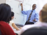 Businessman giving a presentation in front of a whiteboard.
