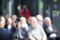 Microphone in front of a mature audience.