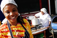 Nigerian women cooking "puff puffs," a deep-fried Nigerian snack