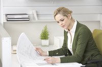 A businesswoman is sitting at a desk.