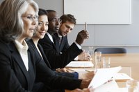 Group of potential investors reading through a proposal.