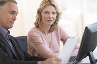 Co-workers using HRIS system on computer