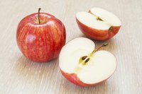 A sliced red apple on a table.
