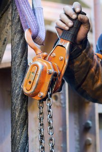 Close-up of man using chain hoist