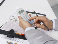 Close-up of financial director using calculator