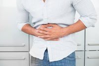 A main clutches his stomach in pain.
