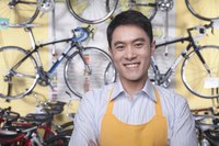 A small business owner standing in his bike shop.
