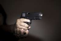 A handgun is being help up.