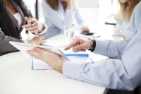 A group of business executives discussing insurance documents