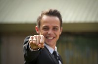 A groom shows off his engagement ring.