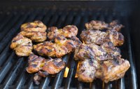 Season the chicken thighs before grilling them, or baste them with sauce while you cook.
