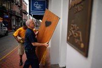 Plywood panels are effective DIY alternatives to commercial storm shutters.