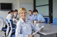 Trainer employee sitting at desk with new hires