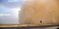 Sandstorms advance like a moving wall.