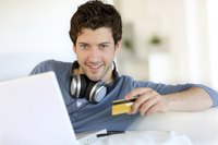 Image of a man holding a debit card.