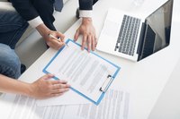 Two businesspeople signing a contract.