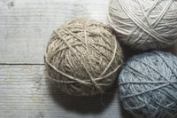 Balls of wool yarn on a table.