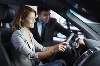 Woman sitting in a car next to salesman.